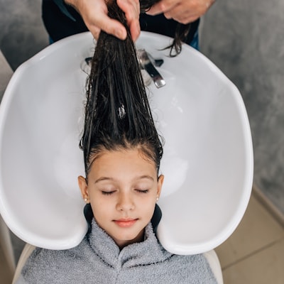 Child receiving a gentle salon hair wash